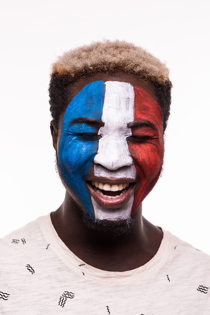 Free photo face portrait of happy afro fan support france national team with painted face isolated on white background