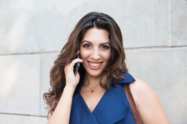 Face of successful businesswoman talking on phone