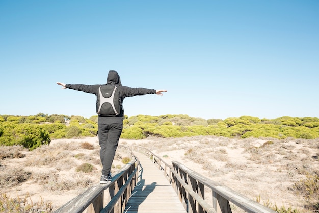 Free photo faceless man walking on railings