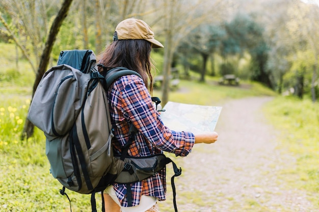 Faceless tourist reading map