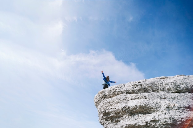 Free photo faceless woman on cliff