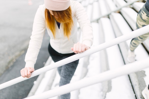 Faceless woman exercising on steps