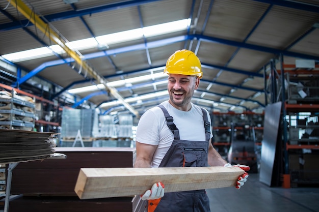 Free photo factory worker carpenter holding wood material and working in furniture industry