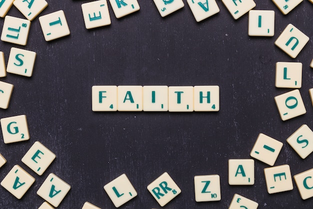 Faith scrabble letters over black background