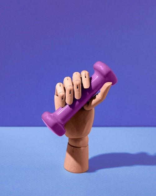 Free Photo fake hand holding dumbbell