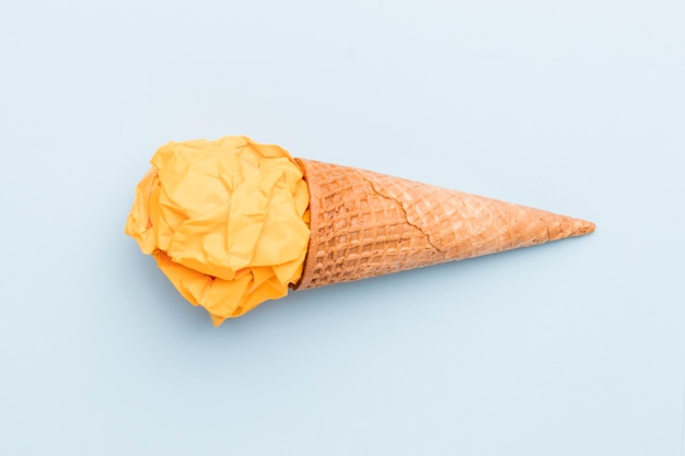 Fake yellow ice cream in sugar cone