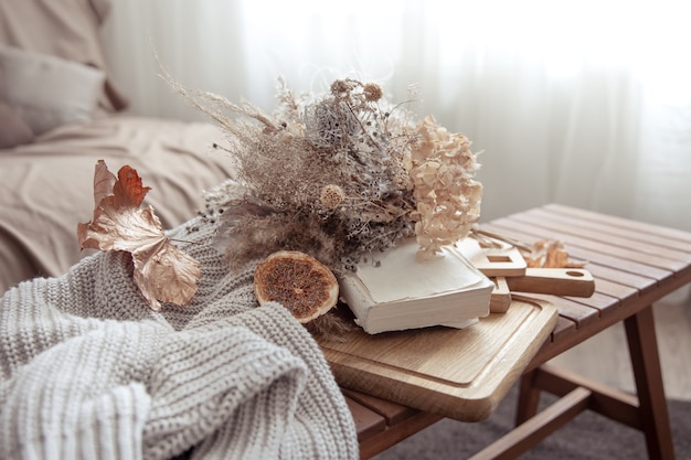 Free photo fall vibe with fall decor details and a knitted sweater in the room.