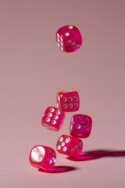 Free Photo falling pink dices on pink background