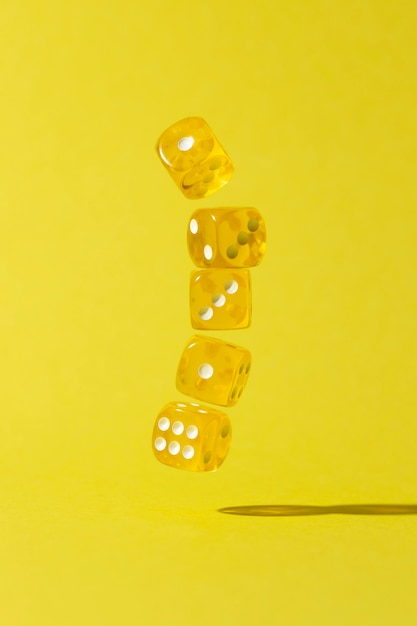 Falling yellow dices on yellow background