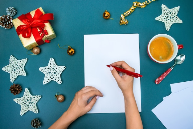 Free photo the famale hands with christmas decorations.