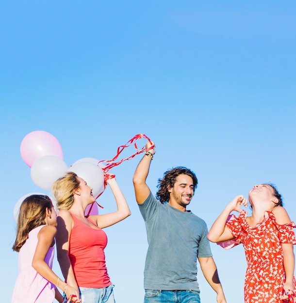 Free photo family around man with balloons