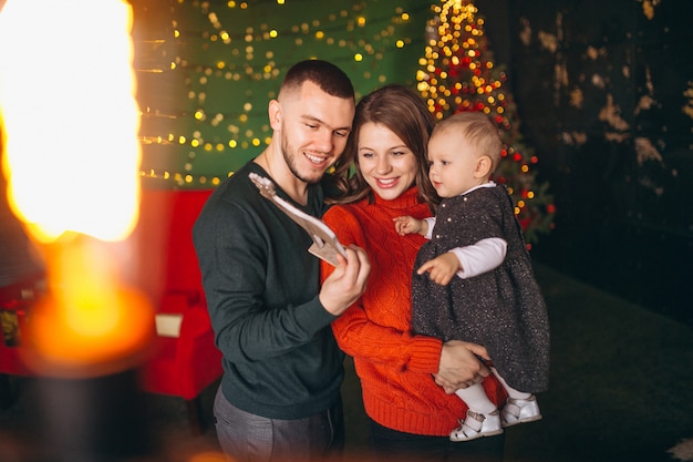 Family on Christmas by the Christmas tree