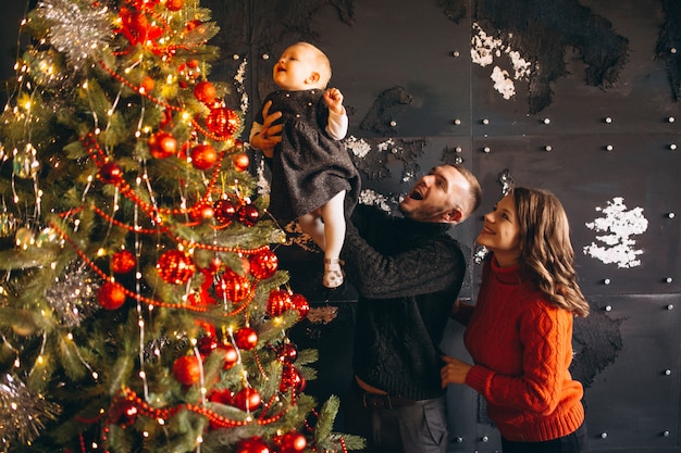 Free photo family on christmas decorating christmas tree