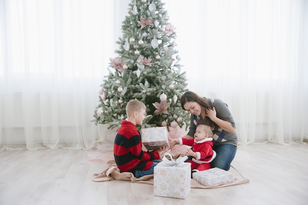 family next to christmas tree