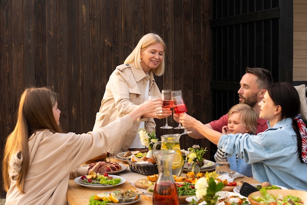 Family clinking glasses medium shot