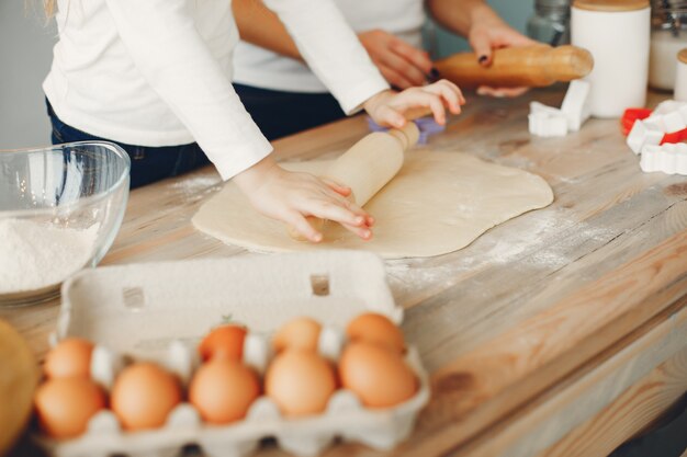 Family cook the dough for cookies