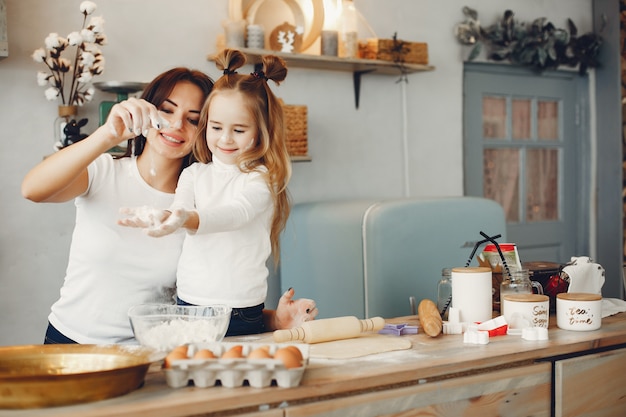 Family cook the dough for cookies