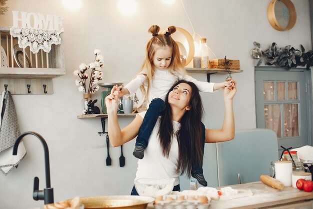 Family cook the dough for cookies