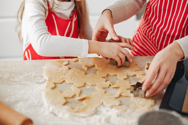 Family cook the dough for cookies