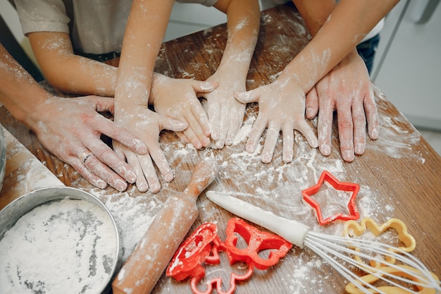 Family cook the dough for cookies