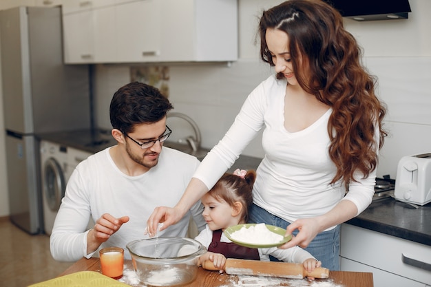 Family cook the dough for cookies