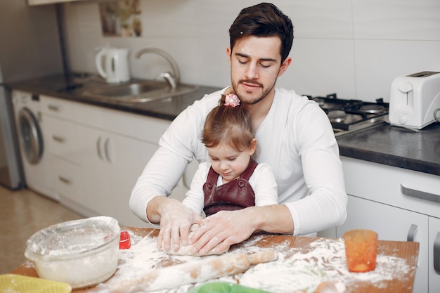 Family cook the dough for cookies