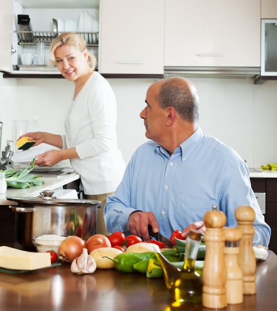 family cooking salad at home