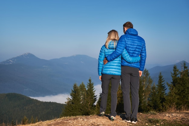 Family couple admiring beautiful mountain scenery