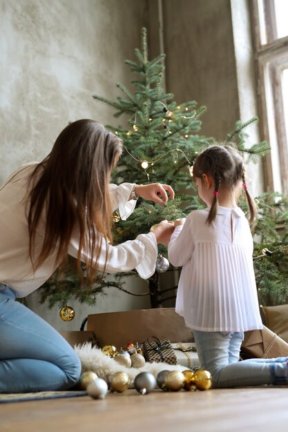 Family decorating Christmas tree