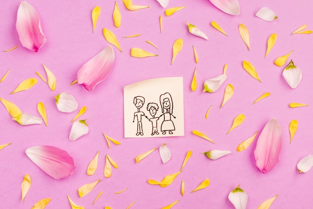 Free photo family drawing on paper among fresh petals