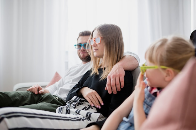 Free photo family enjoying movie on couch