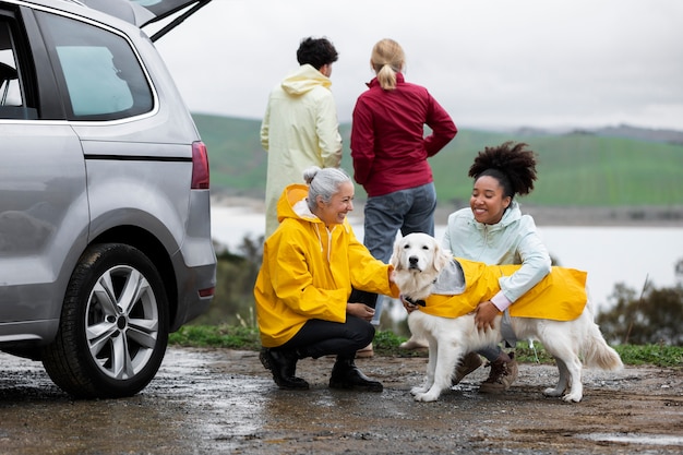 Free Photo family enjoying a road trip with their dog