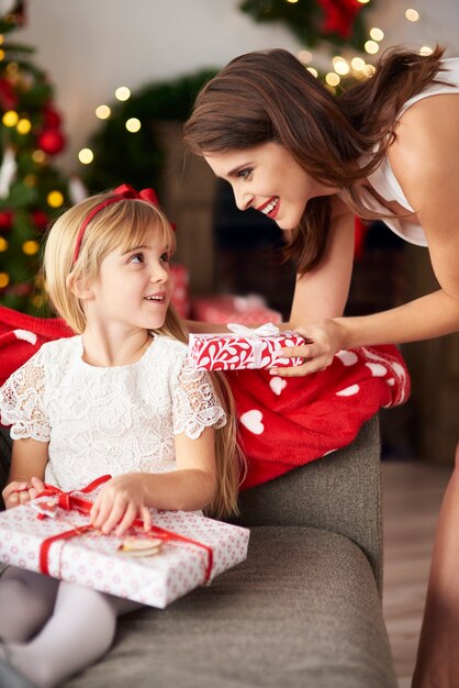 Family exchanging Christmas gifts box