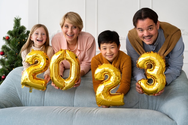 Family of four celebrating new years eve at home together