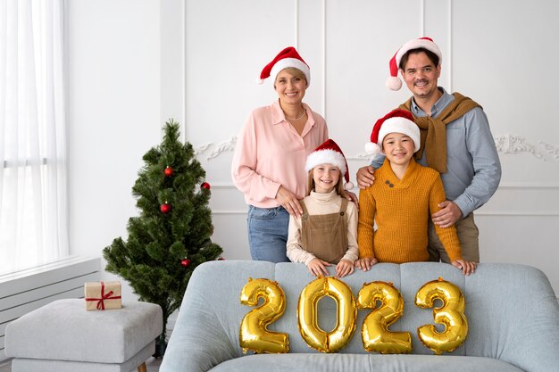 Free Photo family of four celebrating new years eve at home together