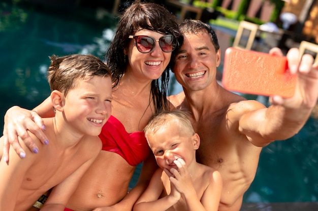 Family of four enjoying a day at the swimming pool together