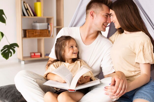 Family having a cute moment together while reading