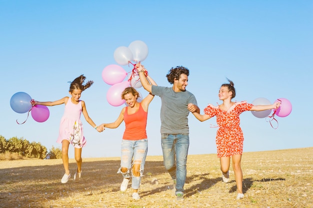 Family having fun in nature with balloons