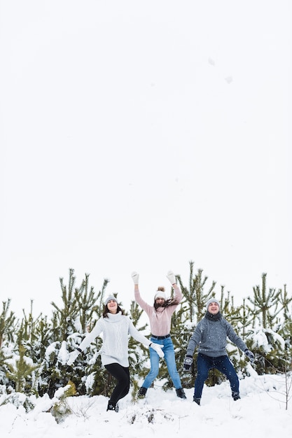 Family having fun near spruces