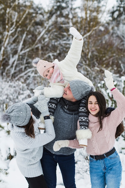 Family having fun in winter forest