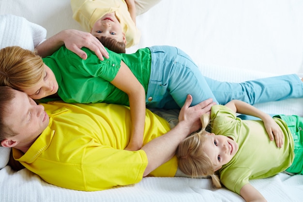 Family having a good time in bed