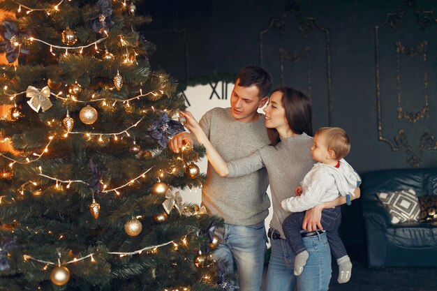 Family at home near christmas tree