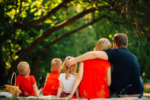 Free photo family hugging each other from behind