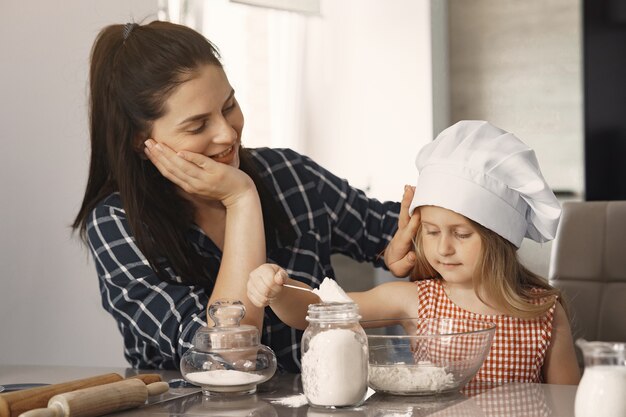 Family in a kitchen cook the dough for cookies