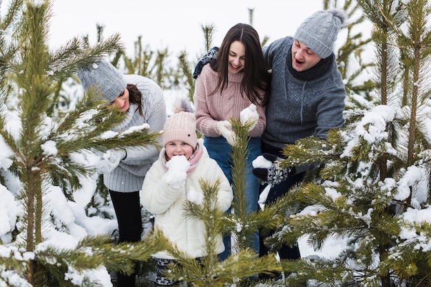 Free photo family looking at girl eating snow