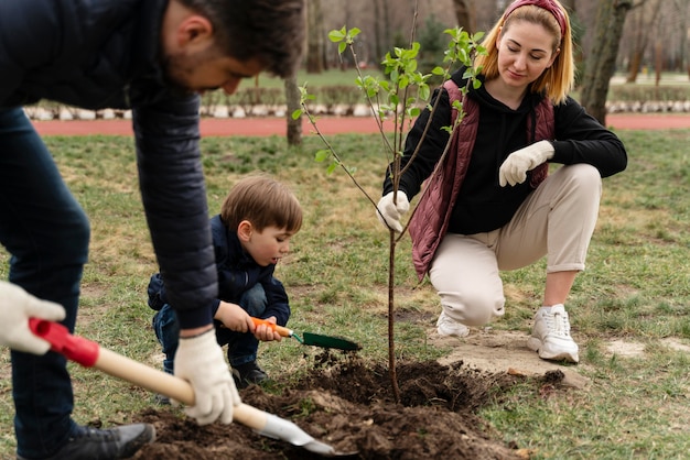 Family plating together a tree