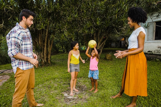 Free photo family playing ball in the garden