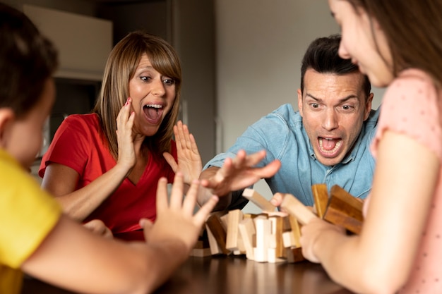 Free photo family playing stacking game together and having fun