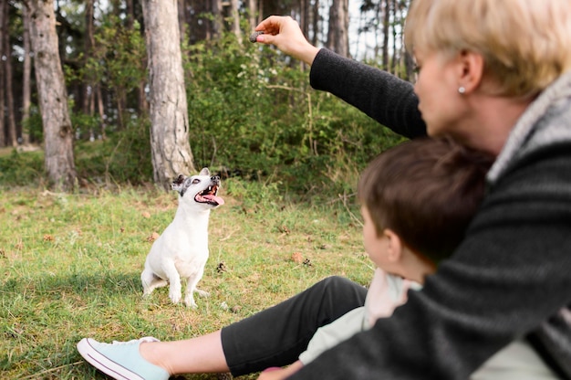 Free photo family playing with adorable little dog