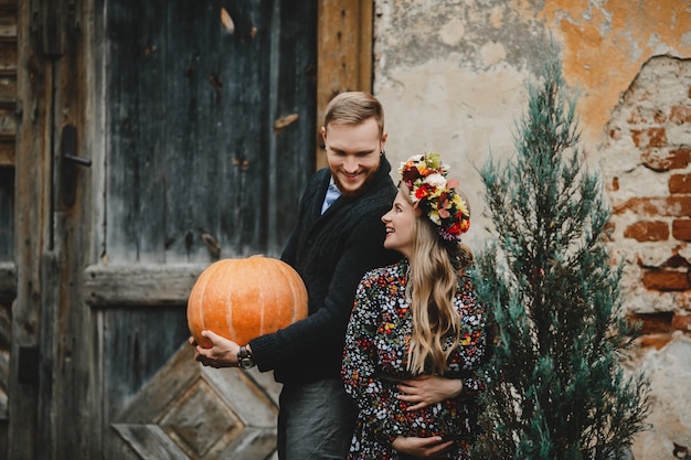 Free Photo family portrait, expacting couple. man hugs tender pregnant woman